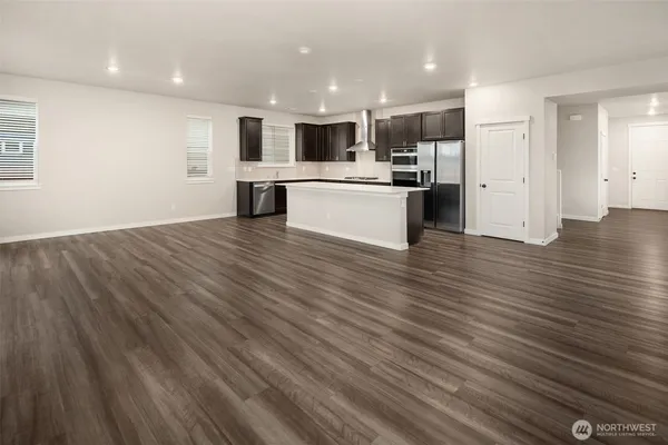 a view of kitchen view wooden cabinets and window