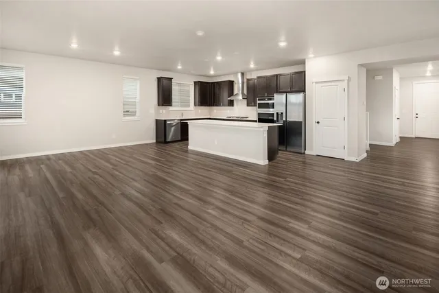 a view of kitchen view wooden cabinets and window