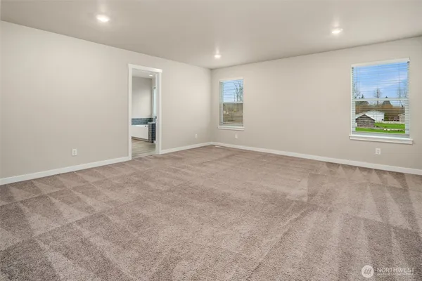 an empty room with windows and closet