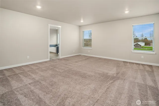 an empty room with windows and closet