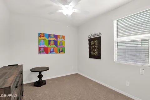 a view of a livingroom with a window and wooden floor