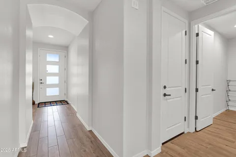 a view of a hallway with wooden floor
