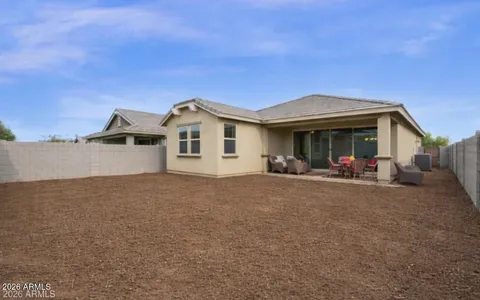 a view of a house with backyard and porch