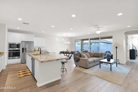 a living room with furniture and kitchen view
