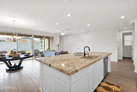 a living room with kitchen island furniture and a wooden floor