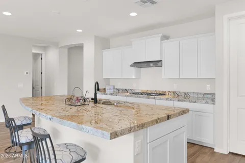 a kitchen with a sink stove and cabinets