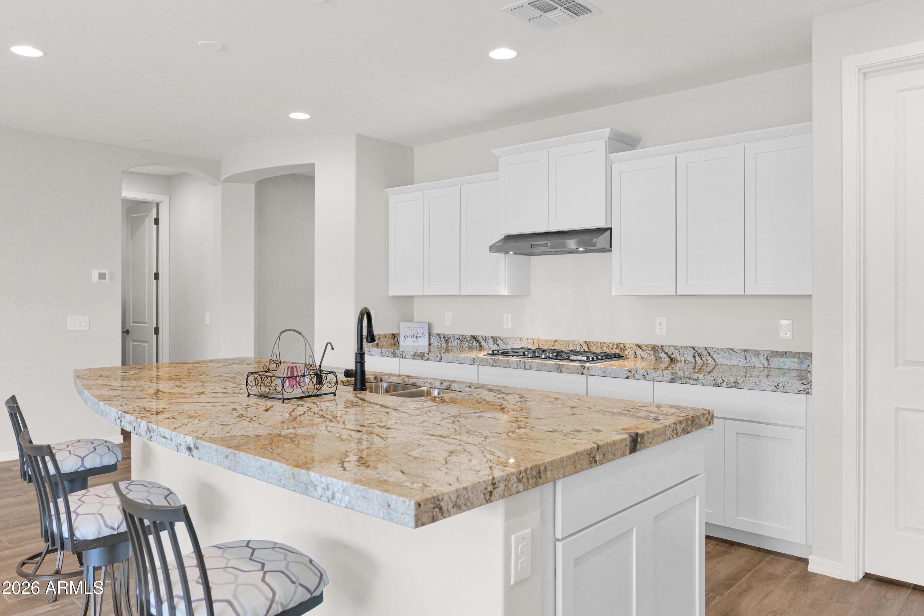 3461 West Oil Well Road San Tan Valley, AZ 85144 - Photo 5 of 25 a kitchen with a sink stove and cabinets