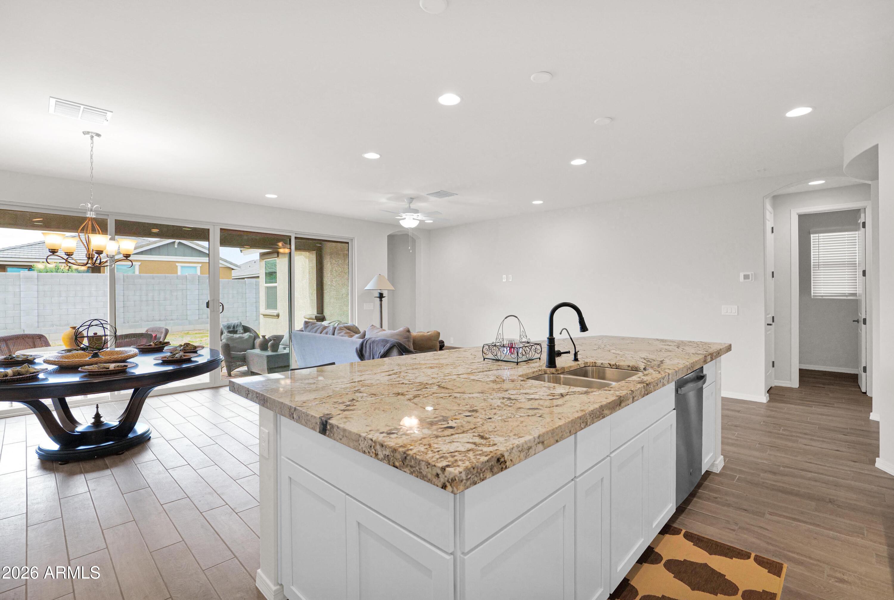 3461 West Oil Well Road San Tan Valley, AZ 85144 - Photo 7 of 25 a living room with kitchen island furniture and a wooden floor
