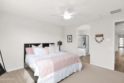 a bedroom with a bed and a chandelier