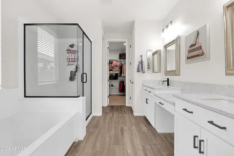 a large kitchen with a lot of counter space and wooden floor