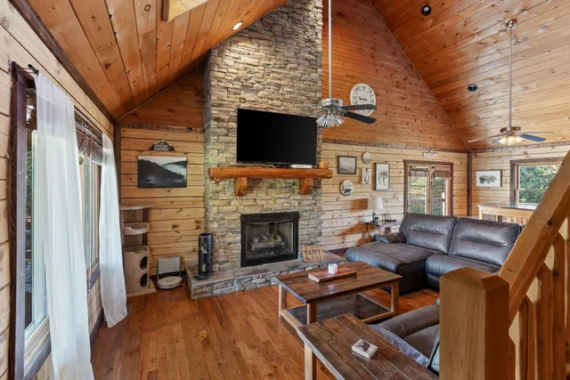 a living room with furniture a flat screen tv and a fireplace