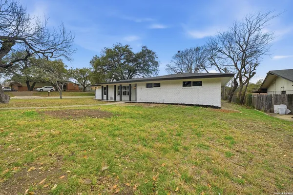 a front view of house with yard and trees