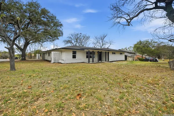 a front view of house with yard and trees