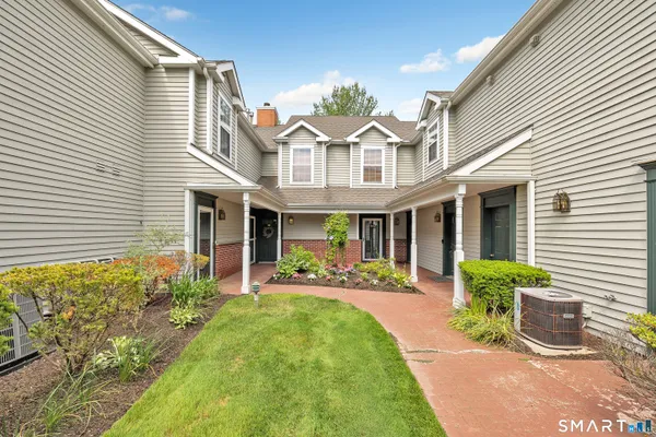 a front view of a house with garden and porch