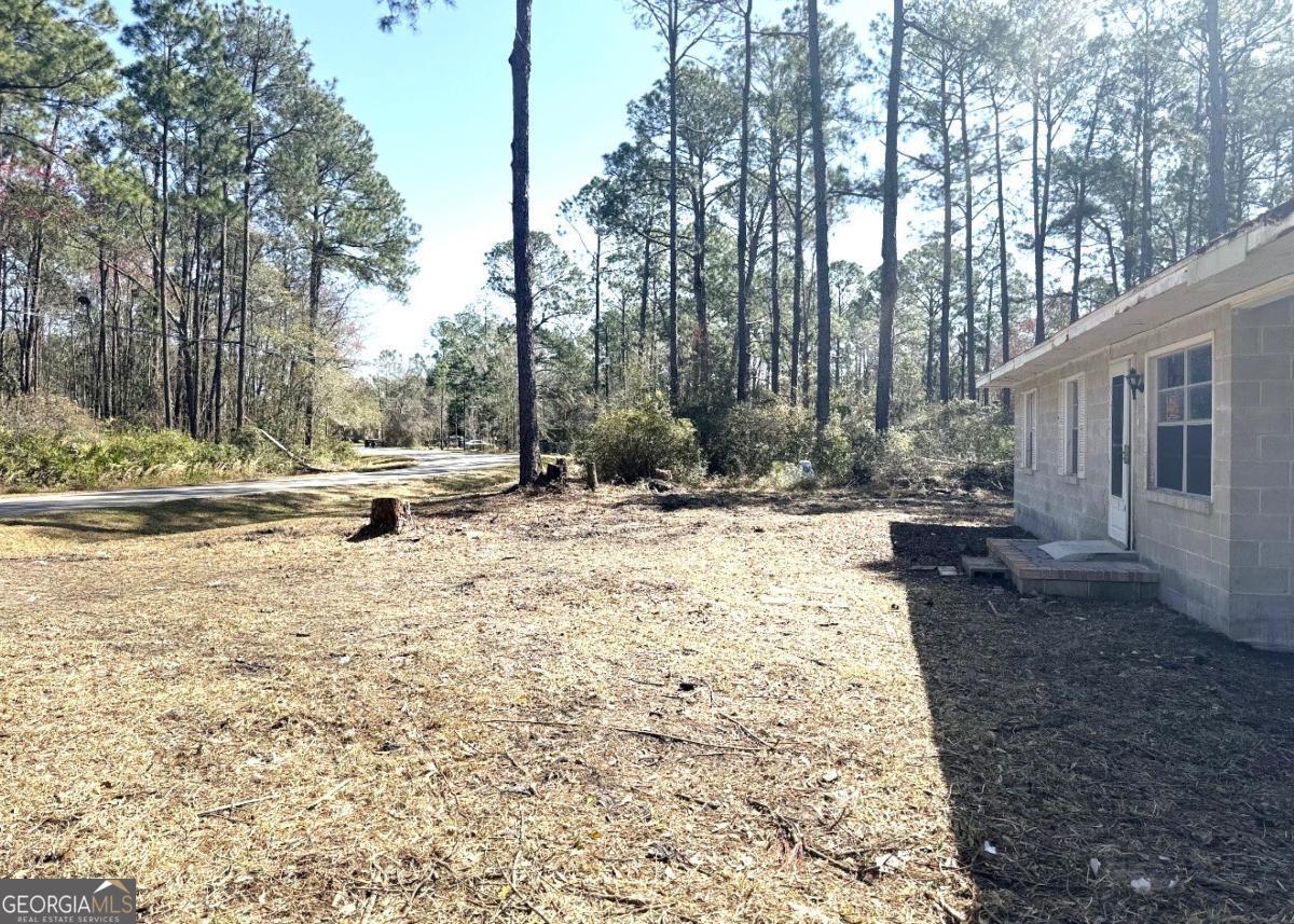 3222 Fred Walker Road Valdosta, GA 31605 - Photo 2 of 2 a view of a yard with trees in the house