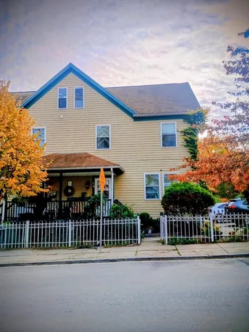 a front view of house with yard and trees