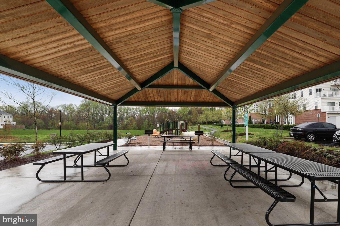 19461 Dover Cliffs Circle, Unit 19461 Germantown, MD 20874 - Photo 11 of 13 a view of a patio with a table chairs and a backyard