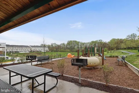 a view of a terrace with couches and wooden floor