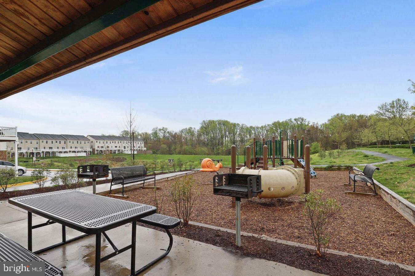 19461 Dover Cliffs Circle, Unit 19461 Germantown, MD 20874 - Photo 12 of 13 a view of a terrace with couches and wooden floor