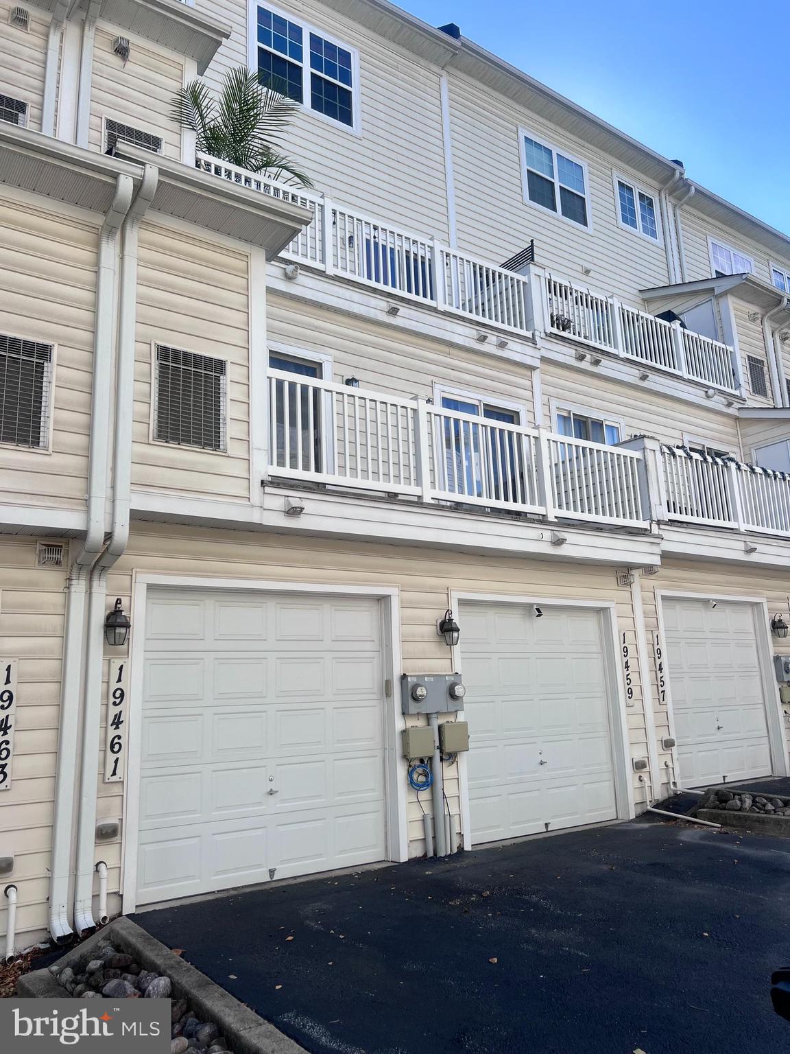 19461 Dover Cliffs Circle, Unit 19461 Germantown, MD 20874 - Photo 7 of 13 a front view of a building with a lots of windows