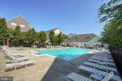a view of a house with a yard and road