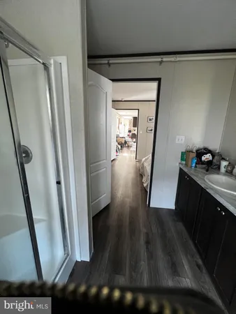a view of a hallway and wooden floor