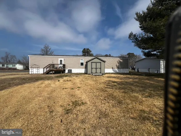 a front view of a house with cars parked