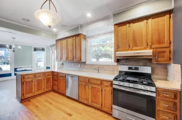 a kitchen with stainless steel appliances granite countertop a stove and a sink