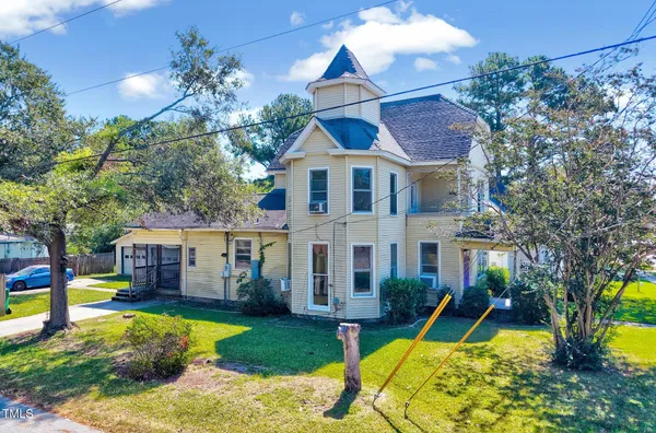a view of a house with a yard patio and a swimming pool