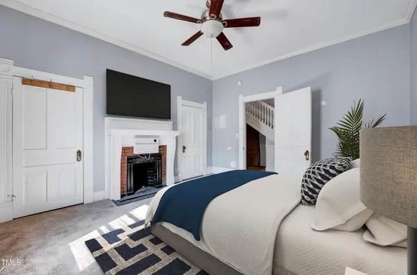 a bedroom with a bed and a television