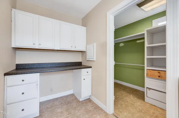 a kitchen with cabinets and a window