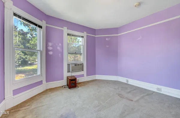 a view of empty room with floor to ceiling window