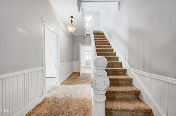 a view of entryway and hall with wooden floor