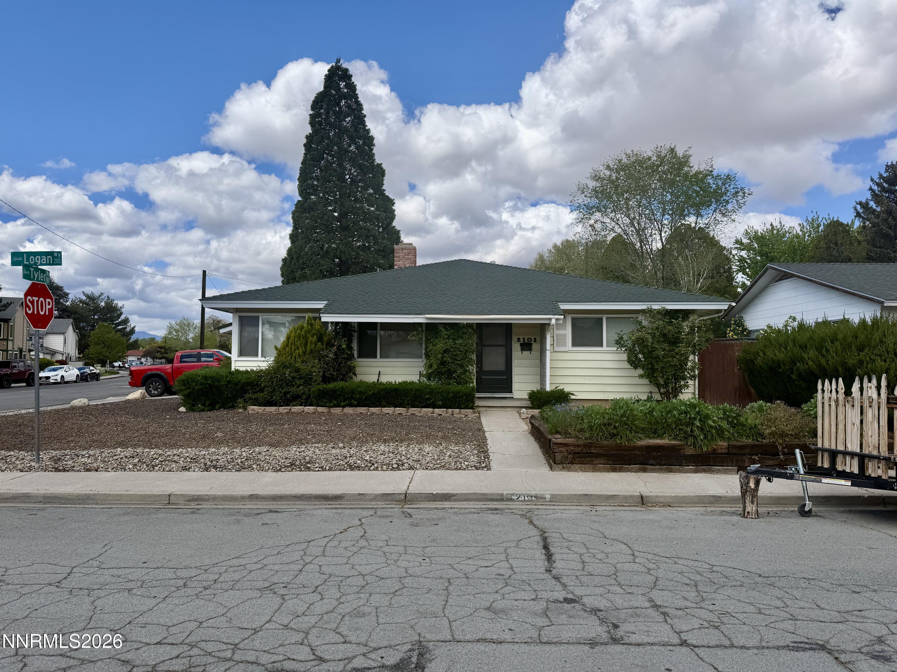 2101 Logan Way Sparks, NV 89431 - Photo 1 of 2 a front view of a house with a yard and potted plants