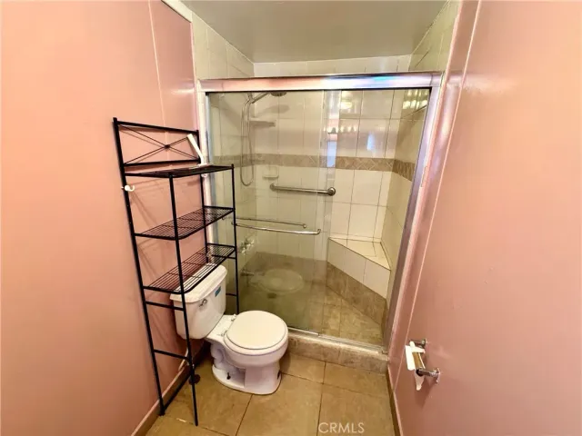 a bathroom with a toilet and a shower