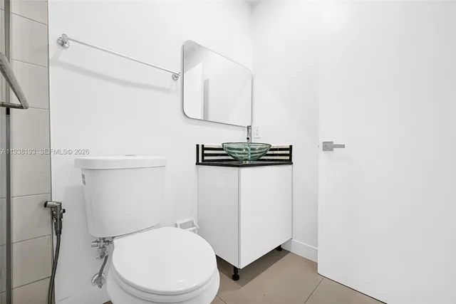 a bathroom with a toilet and a mirror