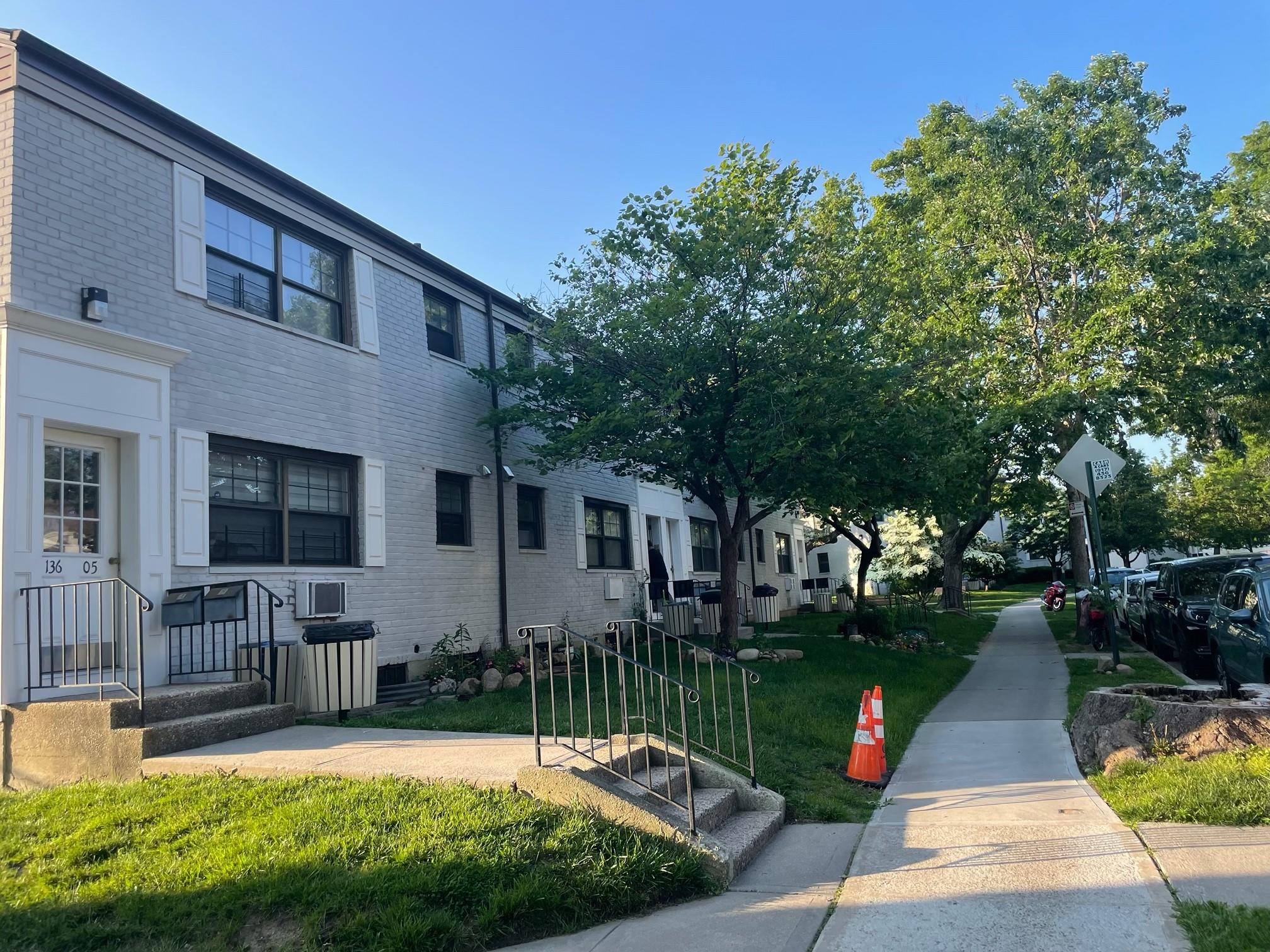 a view of a house with backyard and sitting area