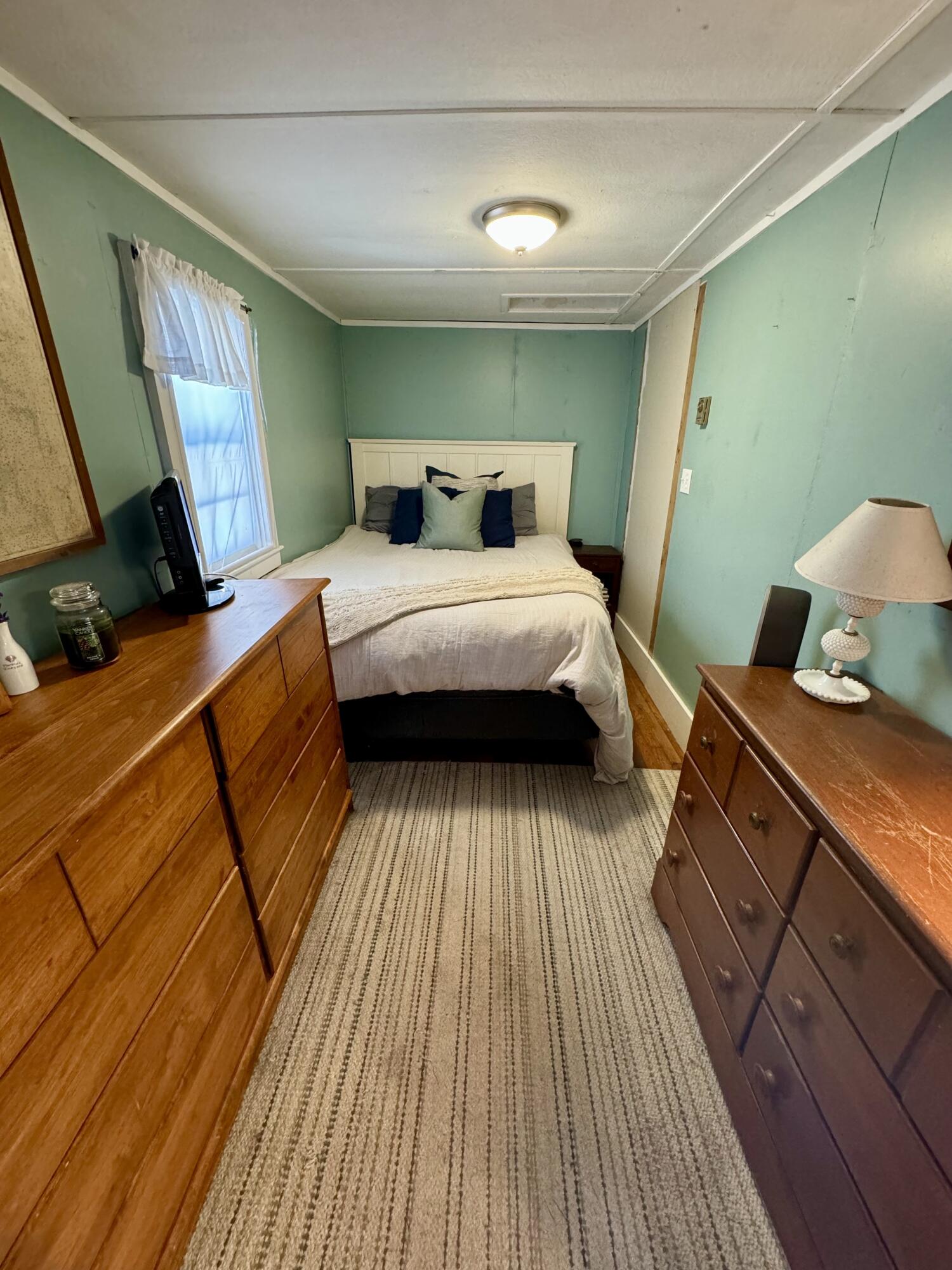 24 The Boulevard Edgartown, MA 02539 - Photo 8 of 14 a bedroom with a bed and wooden floor