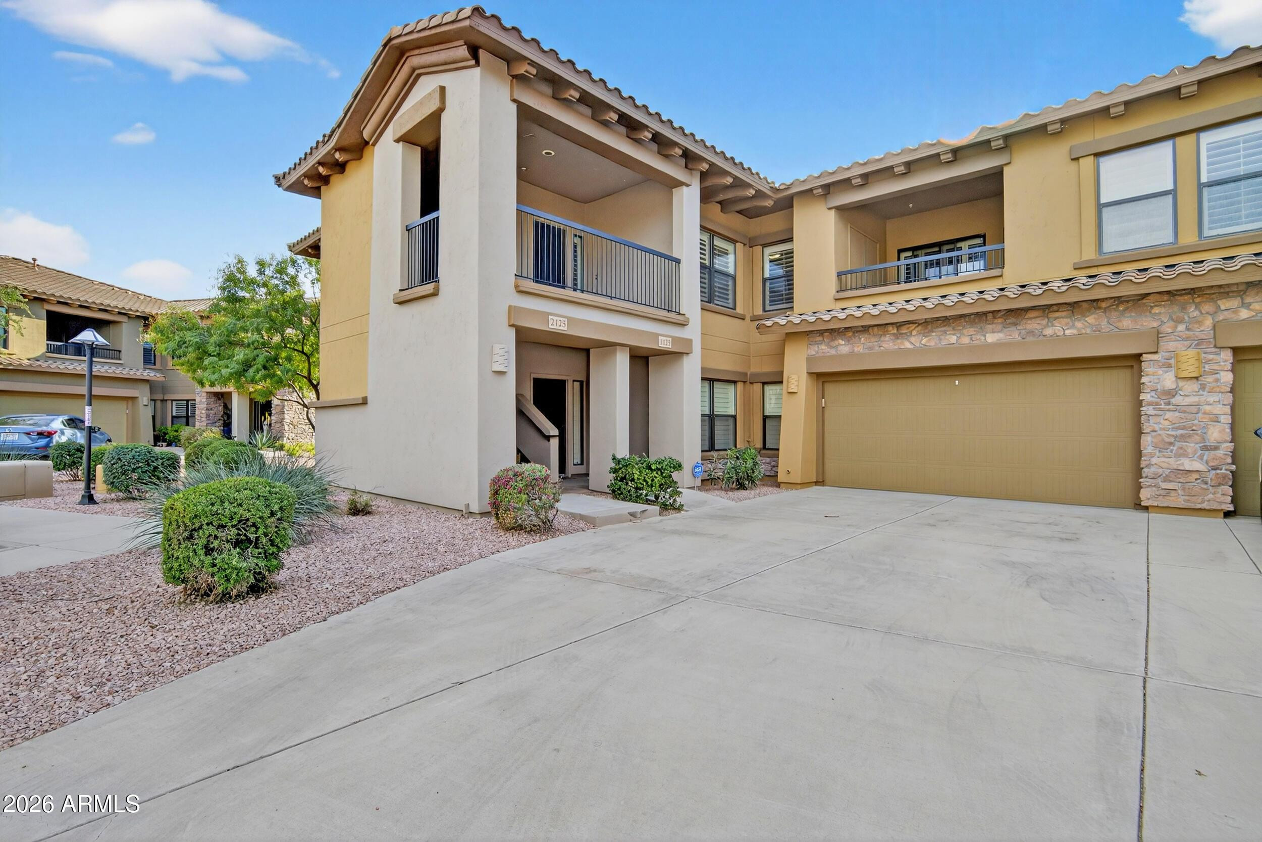 21320 North 56th Street, Unit 2125 Phoenix, AZ 85054 - Photo 1 of 39 a front view of a house with a yard and garage