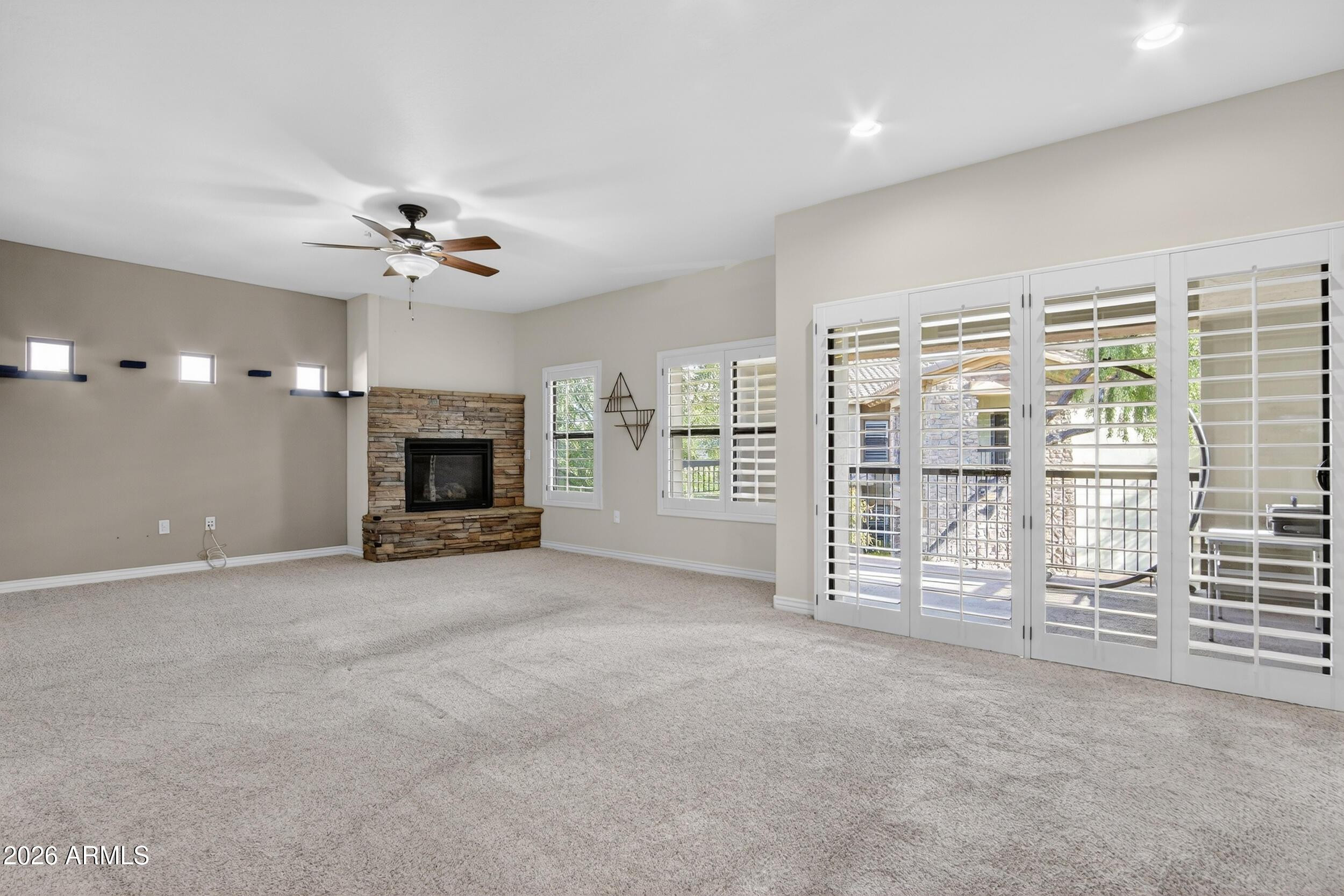 21320 North 56th Street, Unit 2125 Phoenix, AZ 85054 - Photo 11 of 39 a view of an empty room with fireplace and a window