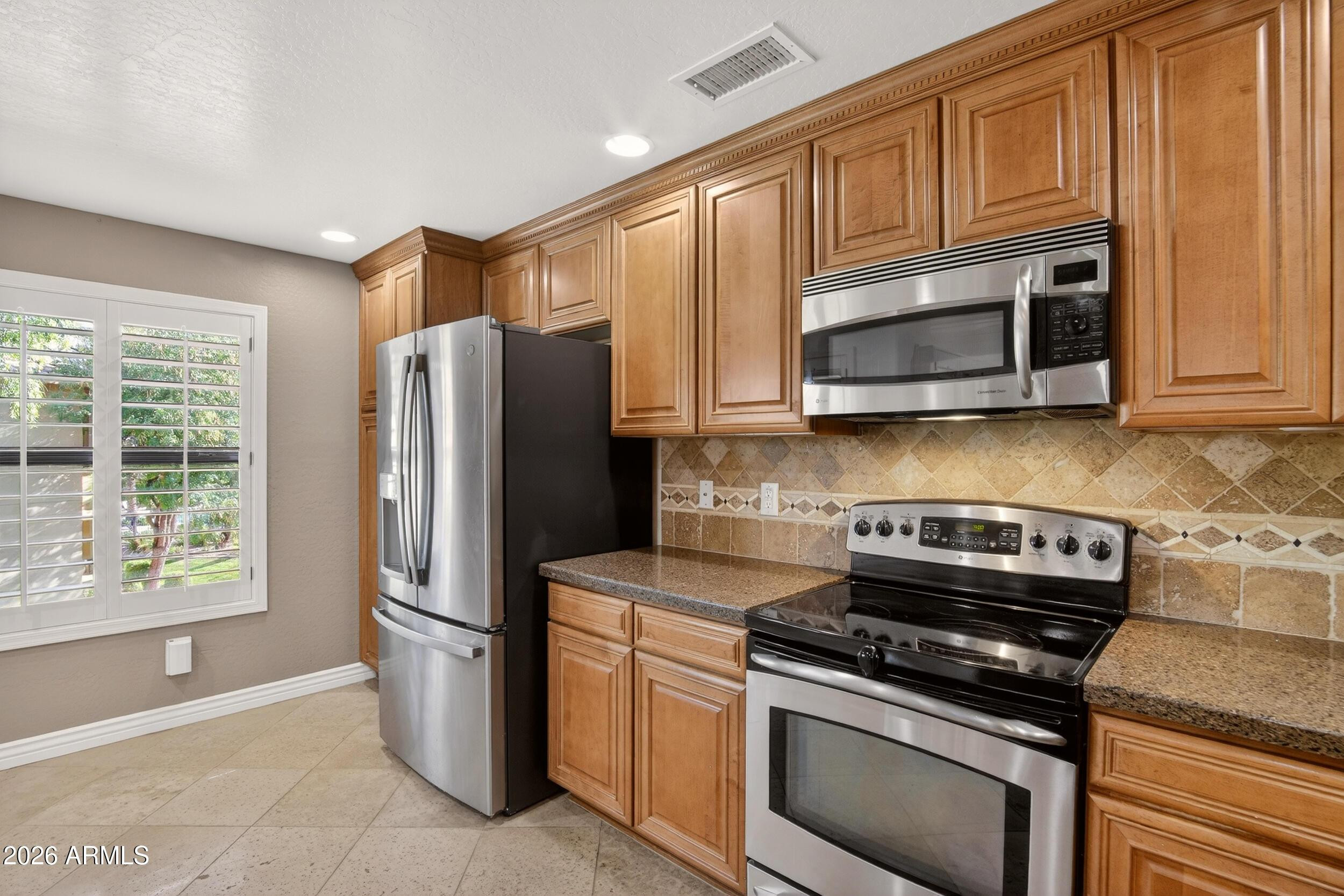 21320 North 56th Street, Unit 2125 Phoenix, AZ 85054 - Photo 14 of 39 a kitchen with stainless steel appliances granite countertop a refrigerator stove and microwave