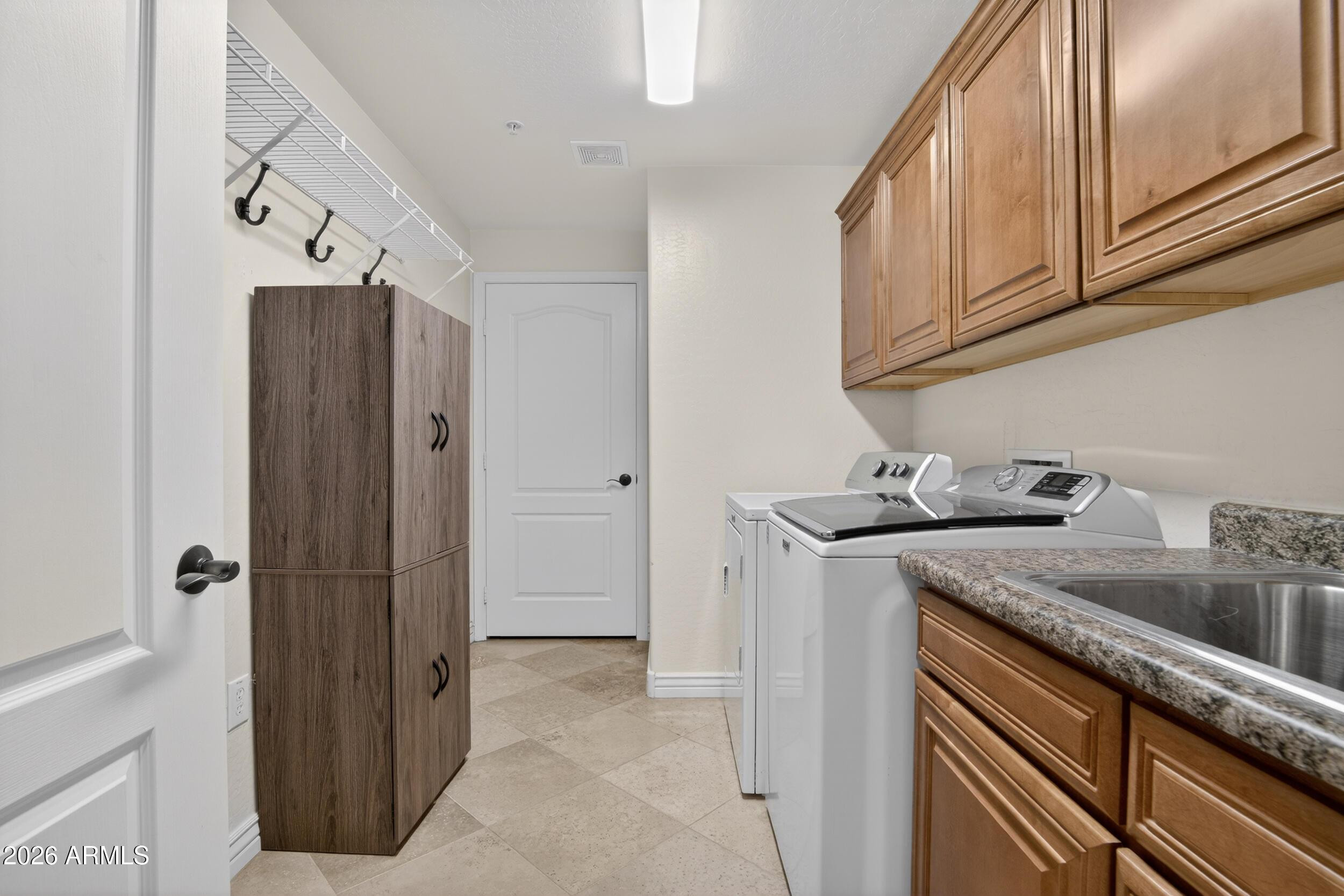 21320 North 56th Street, Unit 2125 Phoenix, AZ 85054 - Photo 15 of 39 a kitchen with stainless steel appliances granite countertop a refrigerator and a sink