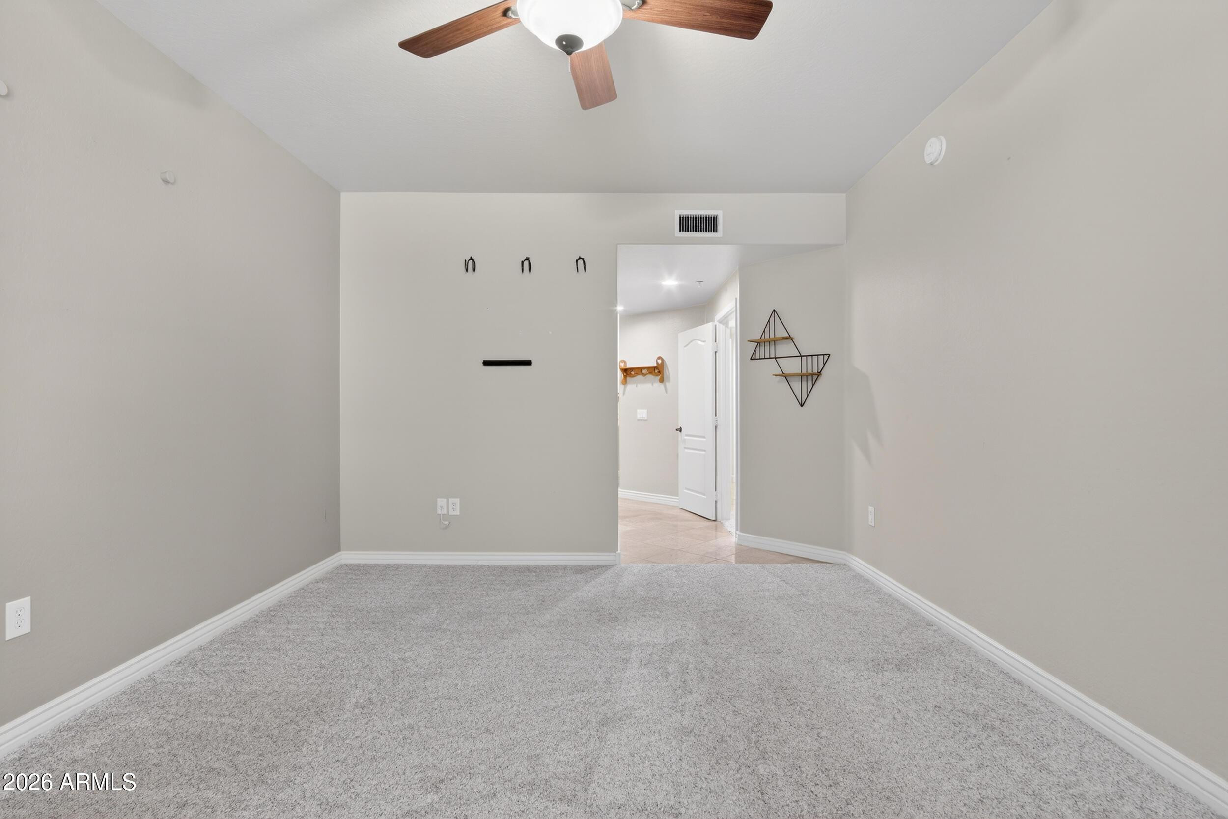 21320 North 56th Street, Unit 2125 Phoenix, AZ 85054 - Photo 24 of 39 an empty room with fan and entrance