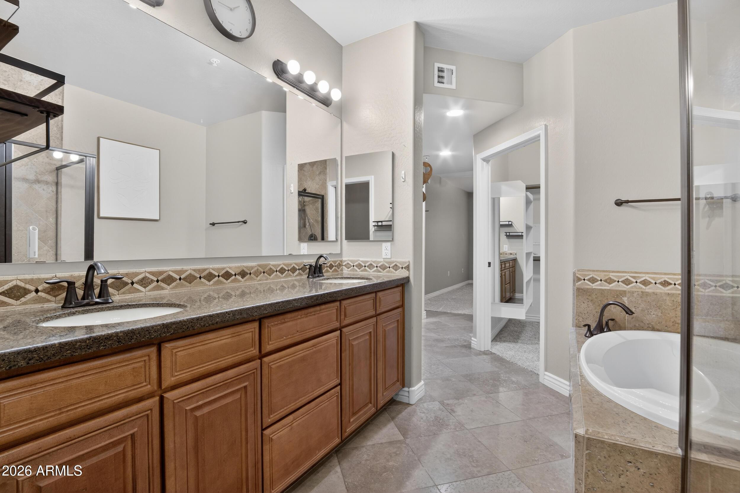 21320 North 56th Street, Unit 2125 Phoenix, AZ 85054 - Photo 28 of 39 a spacious bathroom with a granite countertop sink a mirror a bathtub and a shower