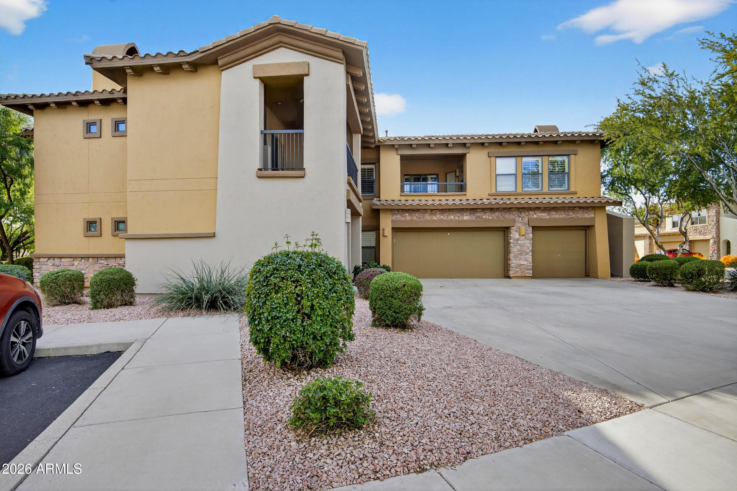 21320 North 56th Street, Unit 2125 Phoenix, AZ 85054 - Photo 3 of 39 a front view of a house with a yard and garage