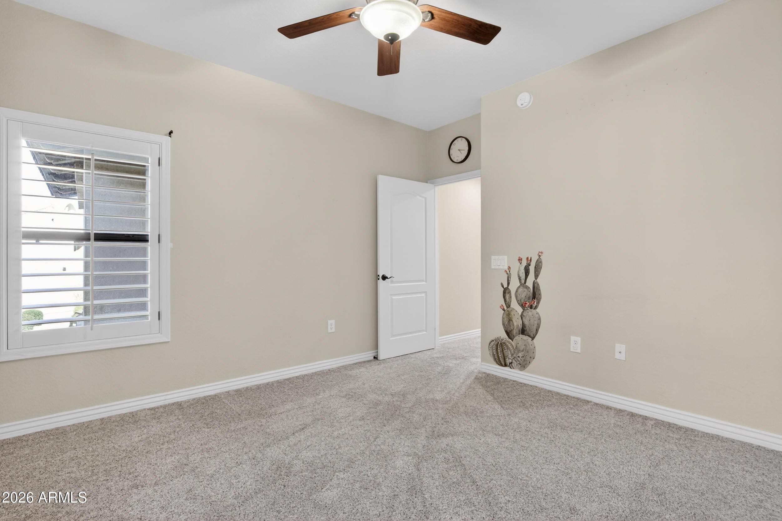 21320 North 56th Street, Unit 2125 Phoenix, AZ 85054 - Photo 32 of 39 an empty room with a ceiling fan and window