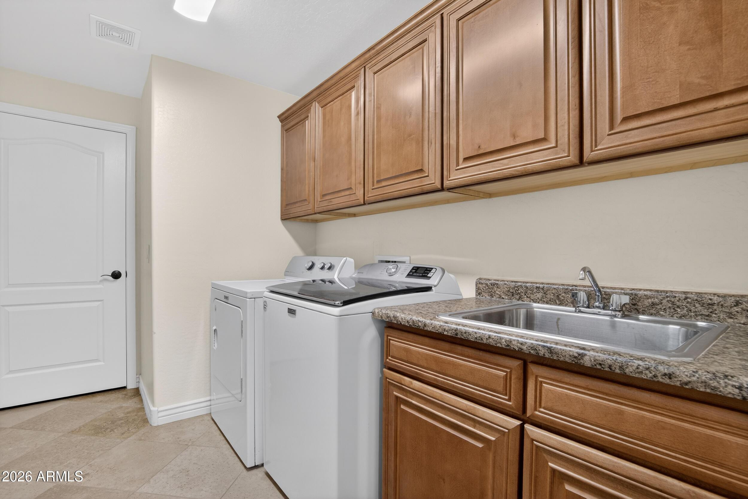 21320 North 56th Street, Unit 2125 Phoenix, AZ 85054 - Photo 38 of 39 a kitchen with stainless steel appliances granite countertop a sink and cabinets