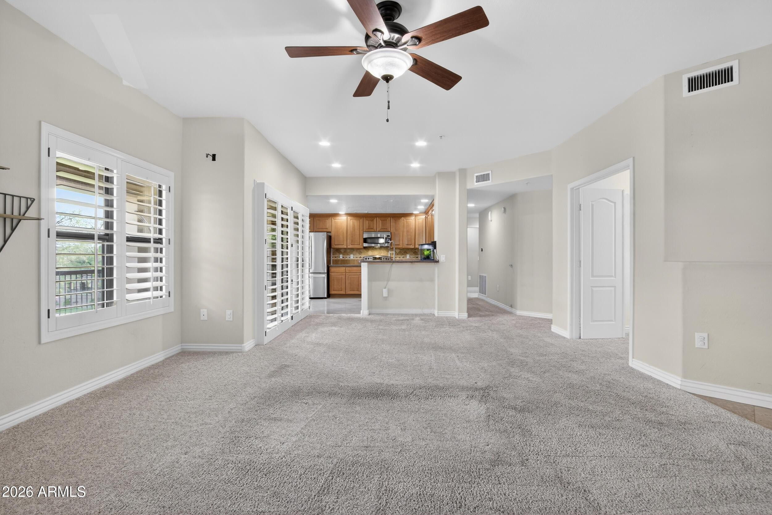 21320 North 56th Street, Unit 2125 Phoenix, AZ 85054 - Photo 8 of 39 a view of a livingroom with a ceiling fan and window