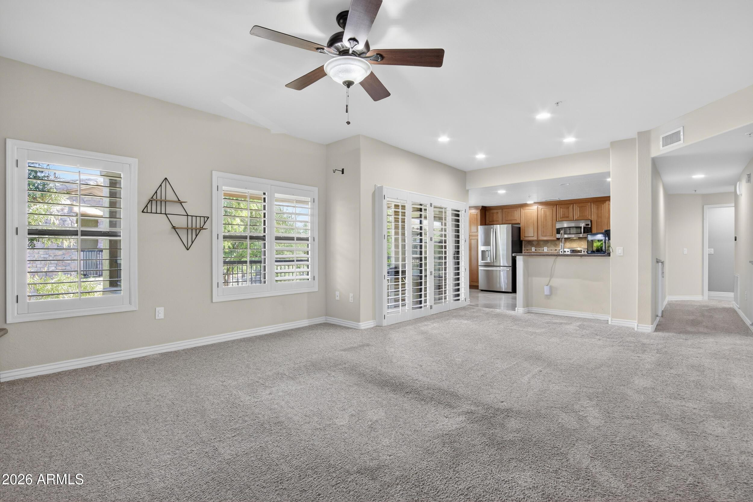 21320 North 56th Street, Unit 2125 Phoenix, AZ 85054 - Photo 9 of 39 a view of an empty room with a window and a kitchen