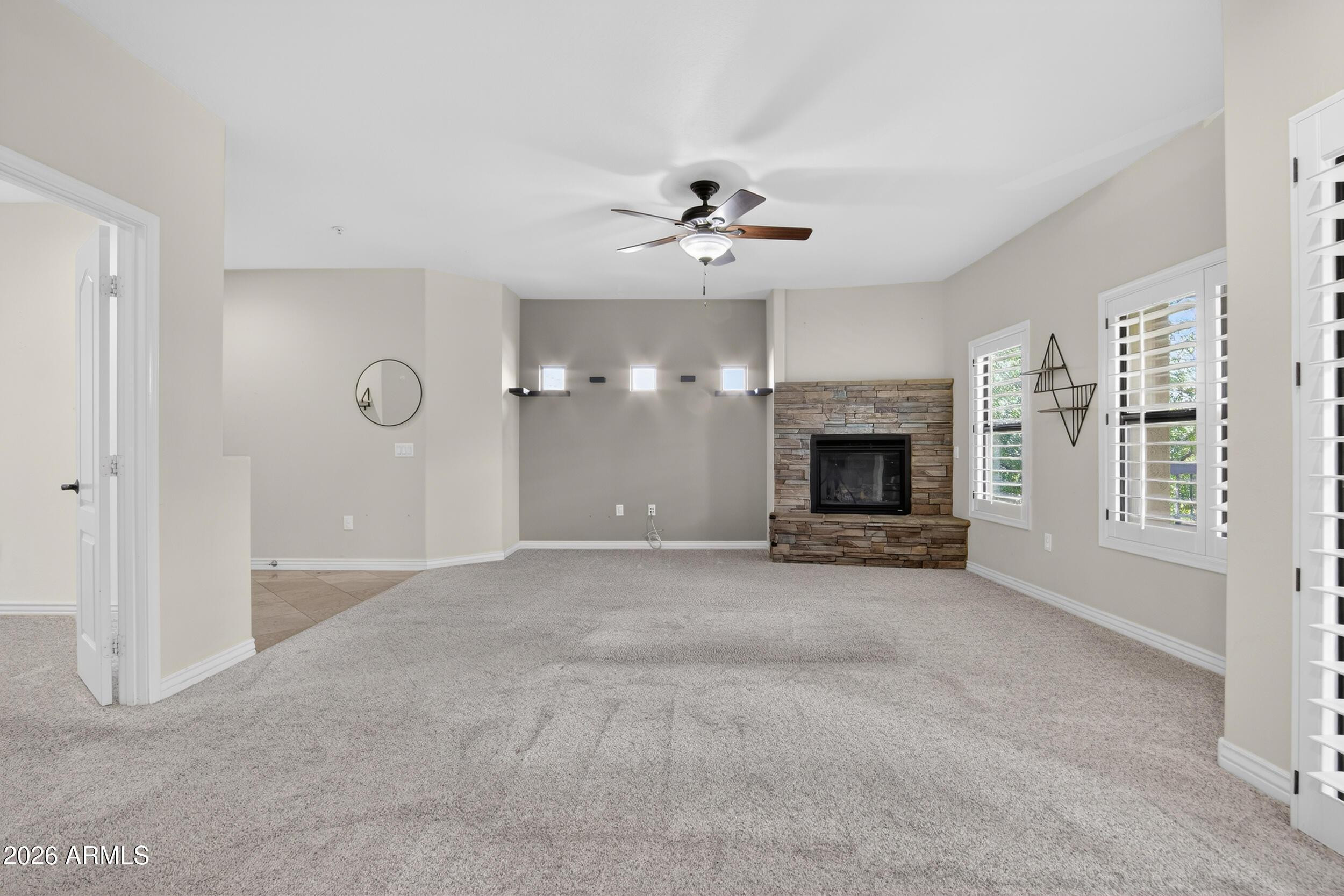 21320 North 56th Street, Unit 2125 Phoenix, AZ 85054 - Photo 10 of 39 an empty room with windows and fireplace